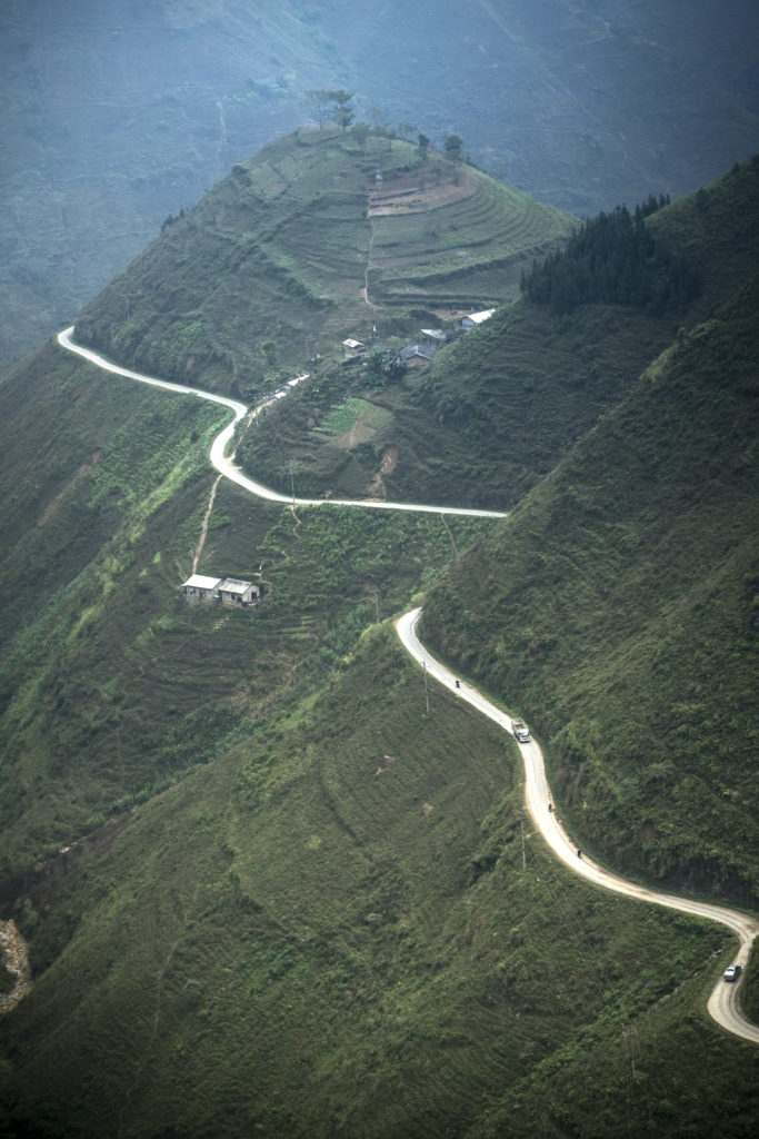 Panoramic view of Ha Giang, Vietnam, mountaineous forests with road rolling across