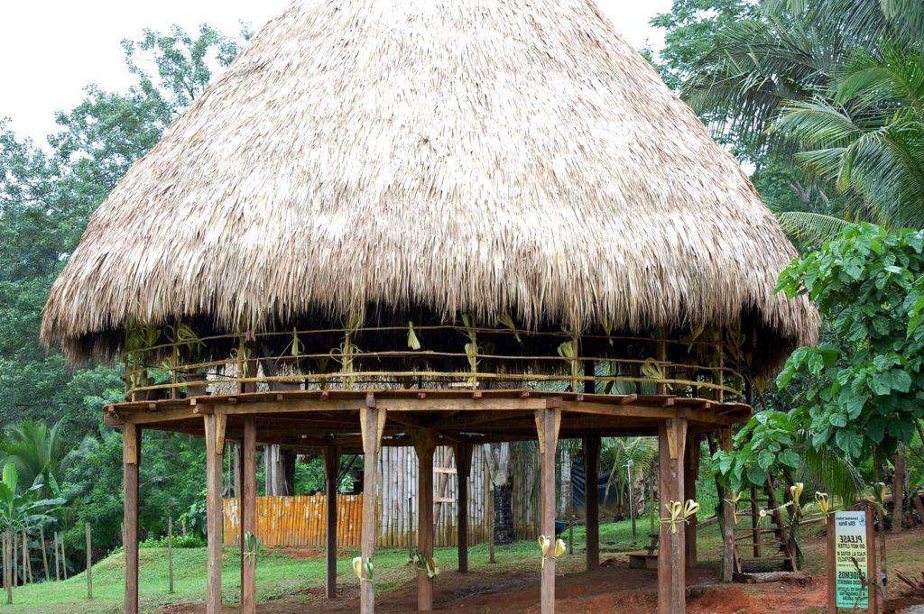 Eco-Lodge built with brown branches and leaves on stilts in Panama, positive impacts of tourism