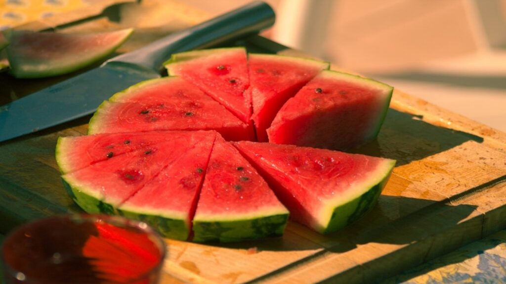 bariatric surgery, red and green watermelon slices on wooden chopping board and steel knife
