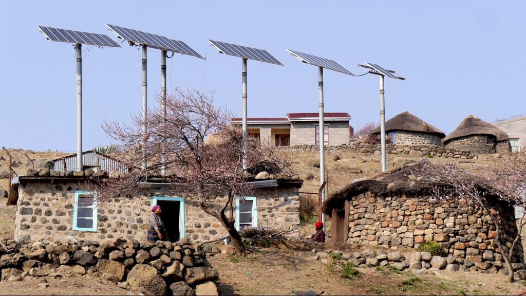 Solar panels capturing solar energy on rural houses made of grey rocks in Lesotho