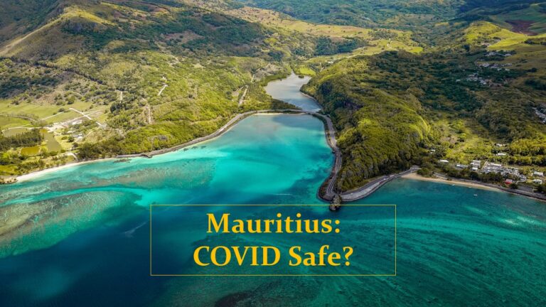 Green mountains in background bluish green sea with words mauritius covid safe written in yellow box; covid19 pandemic