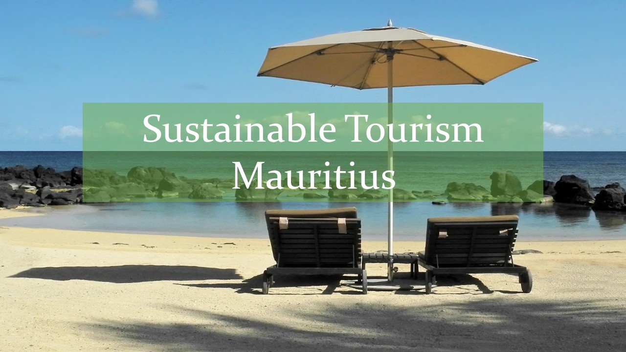Two brown beach chairs on white sand with cream coloured beach umbrella in front of rocky sea with words sustainable tourism Mauritius written on it
